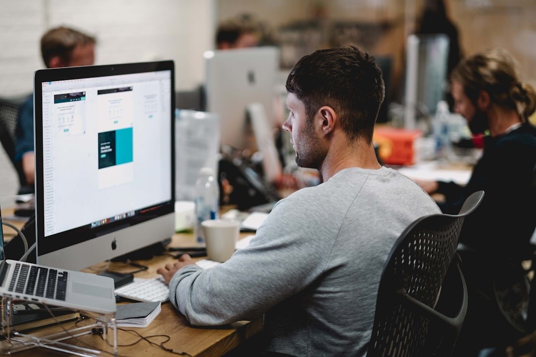 Media analyst reviewing audience engagement data on multiple monitors